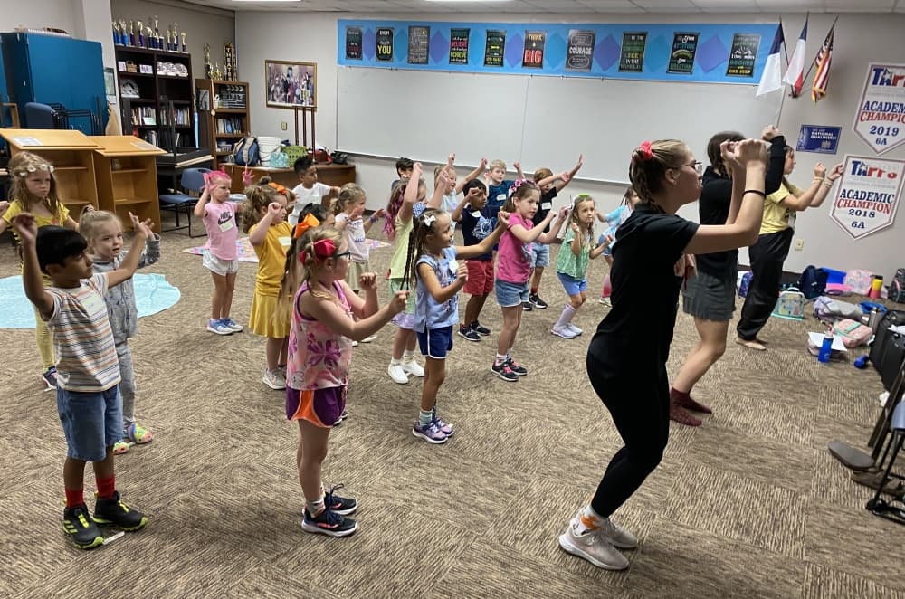 Children follow instructions in a performance rehearsal
