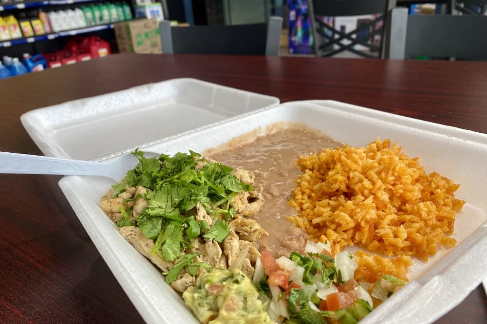 Chicken, rice and beans on a plate.