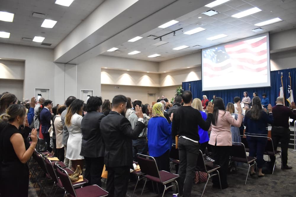 People standing to be sworn in