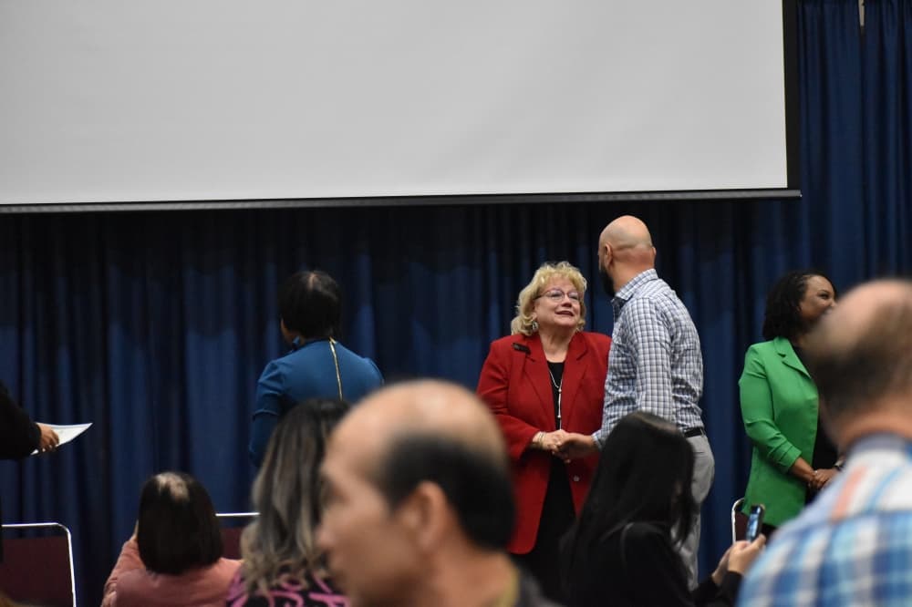 Two people shaking hands and talking