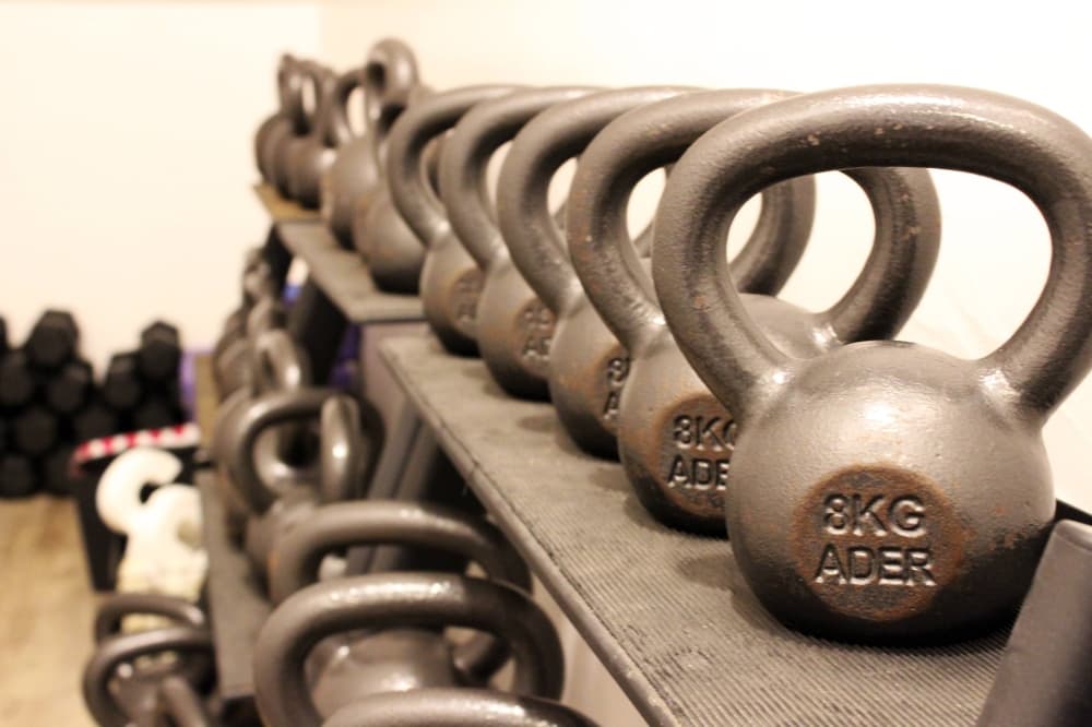 Kettlebells on an equipment shelf.