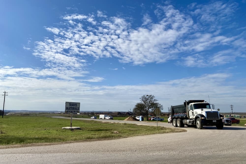 Truck carrying sand and gravel.
