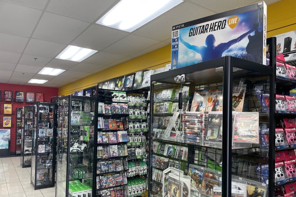 Video games and video game equipment line the shelves of Game Over Videogames' store interior in McKinney