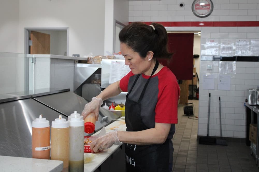 Yan Upchurch making a sandwich.