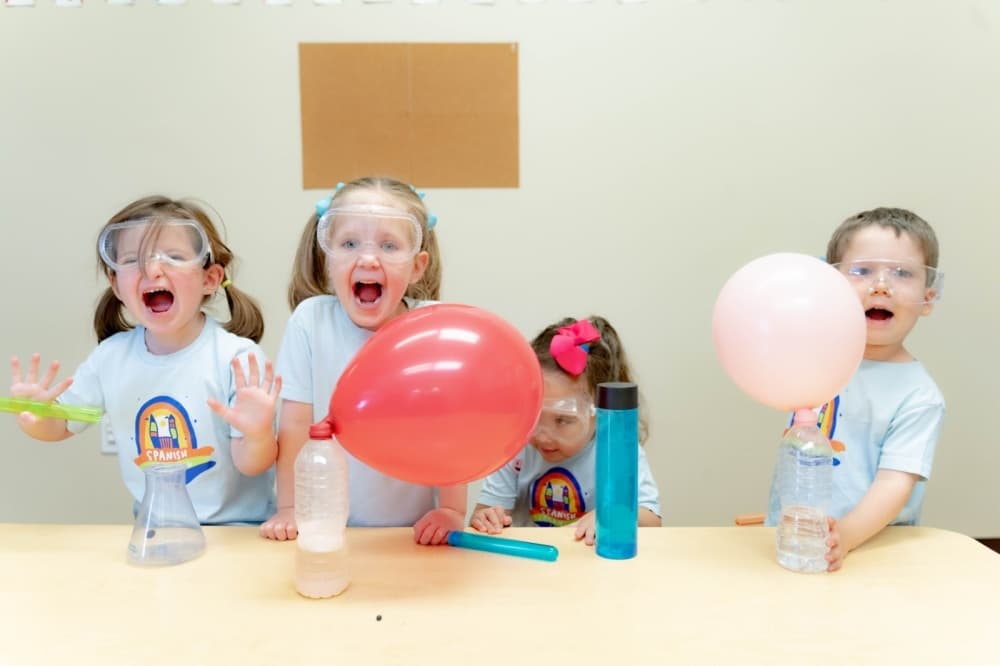 students inflate balloons during an experiment 