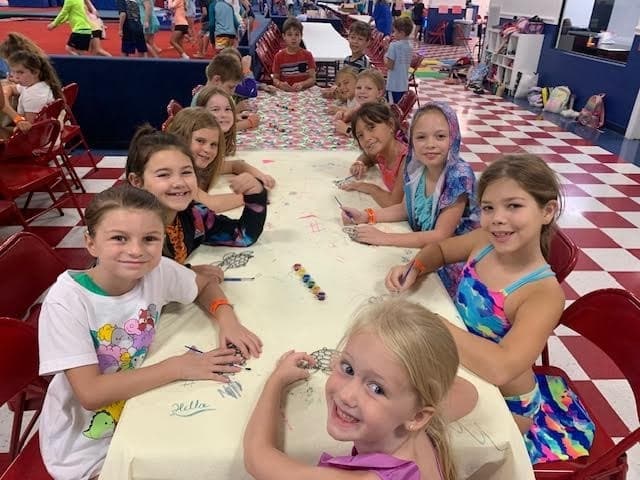 students color on a tablecloth