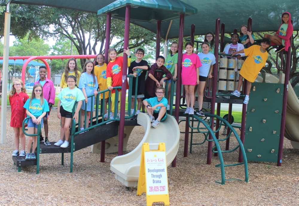 a group of campers pose for a photo at the playground