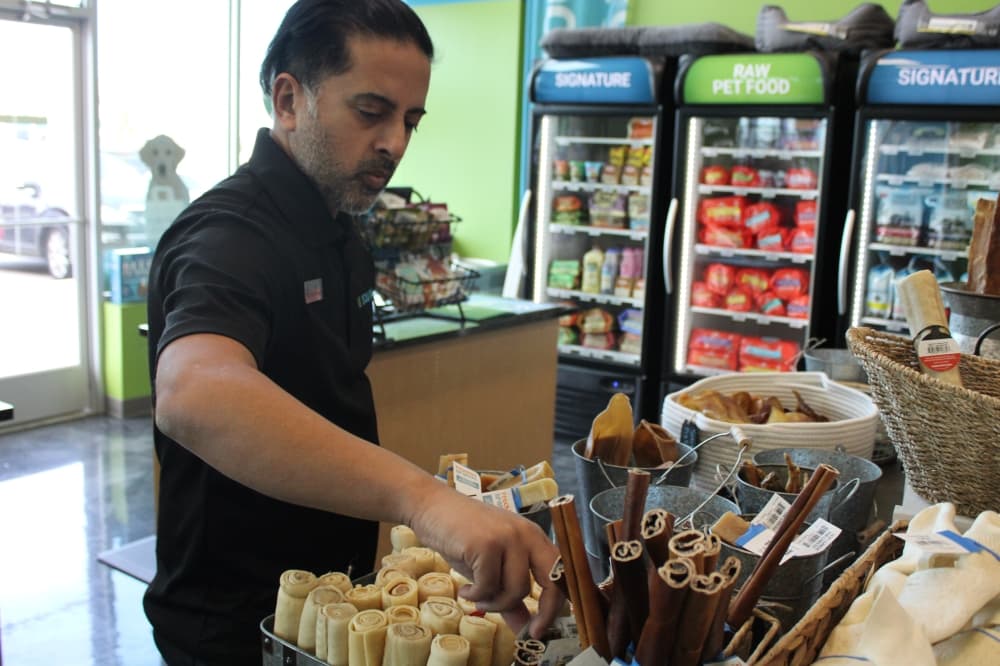 Pet Evolution owner Neil Sheth organizing a display. 