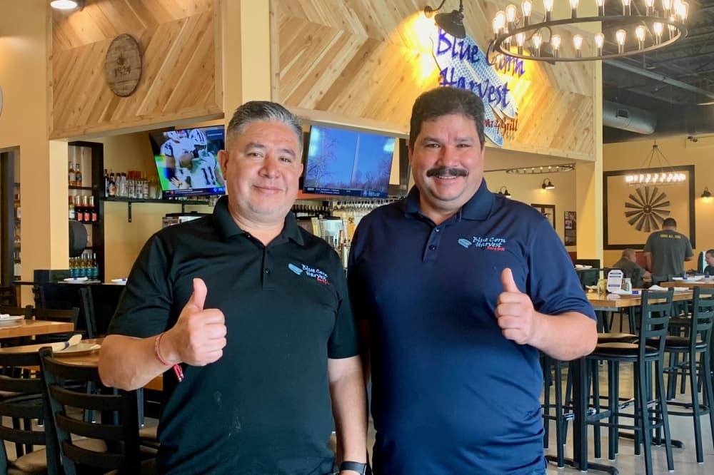 two men give thumbs up