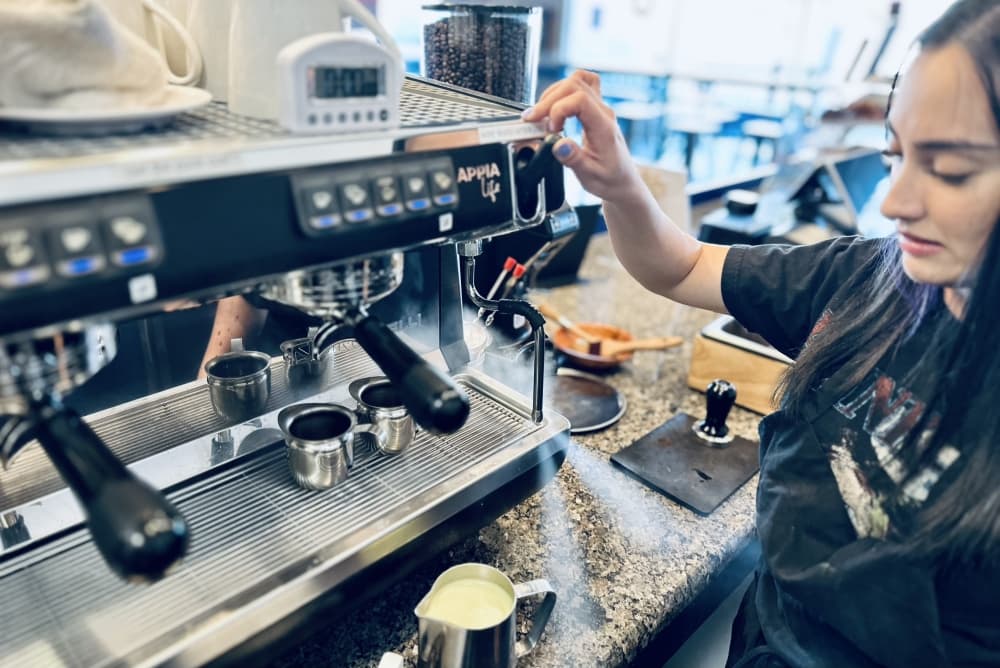 Head barista Kelly Randolph creates steam with the steam wand.