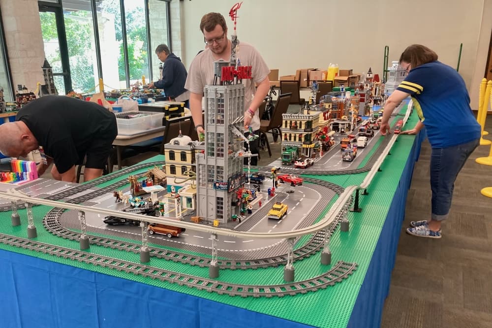 people working on a model railroad display 