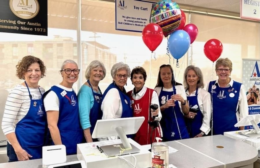 A group of volunteers pose for a photo at the thrift store.
