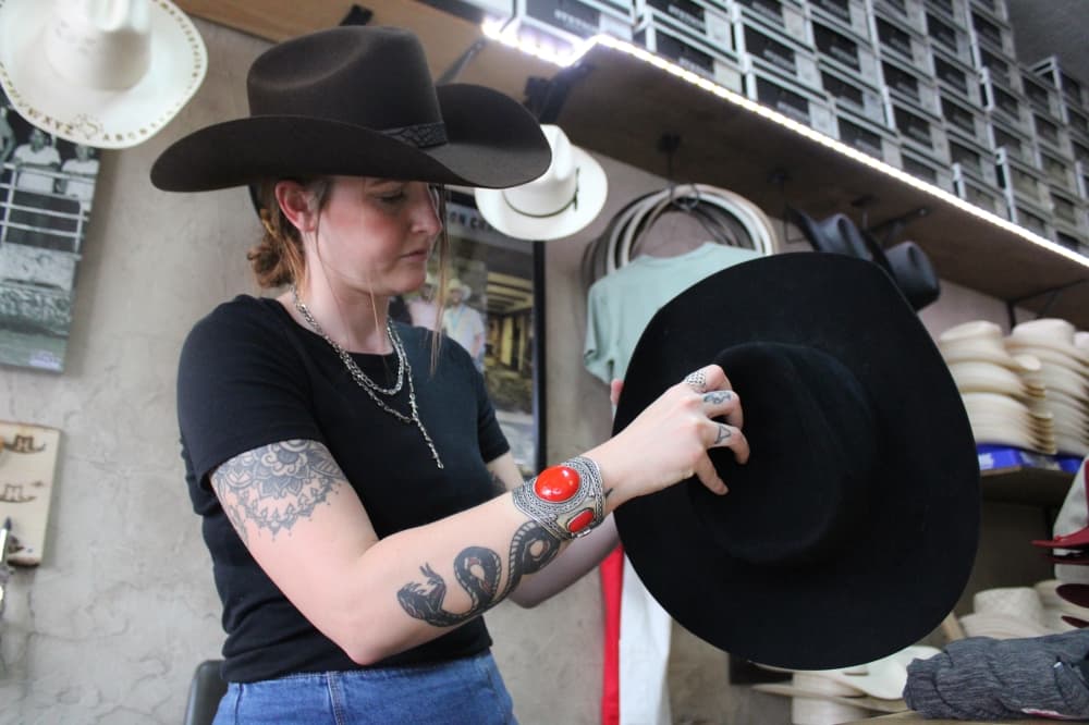 McKinney Hat Company employee shapes a hat. 