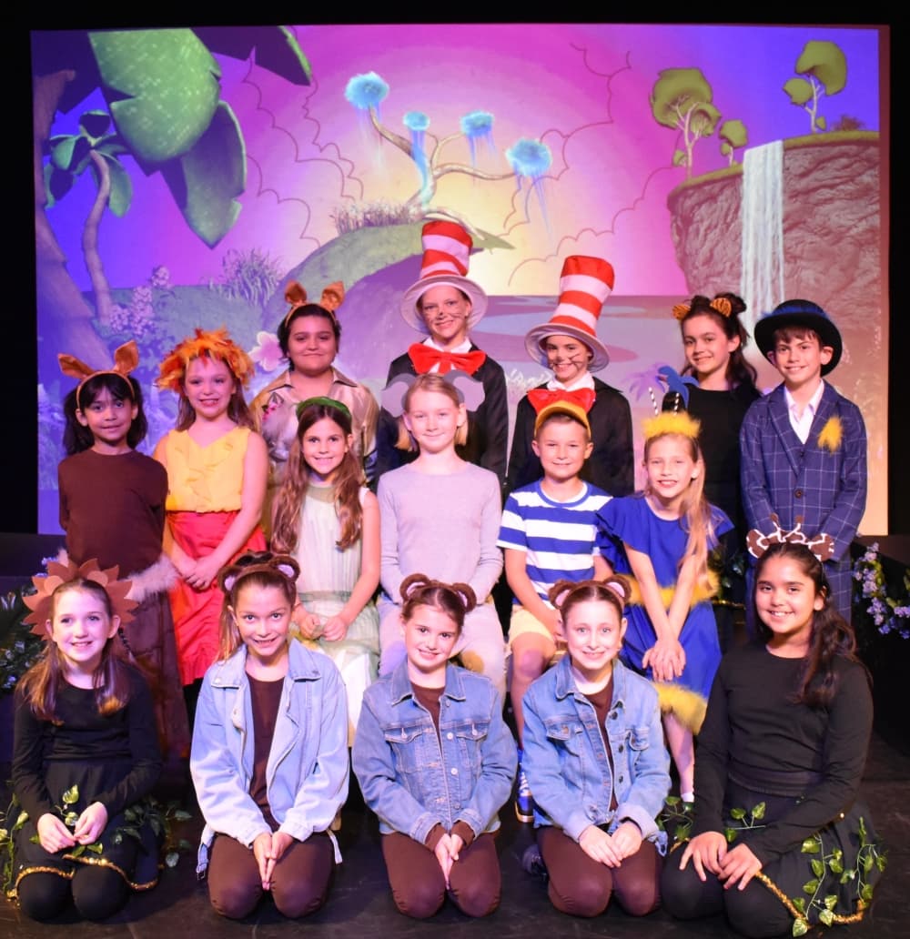 Kids posing for a photo in theater costumes