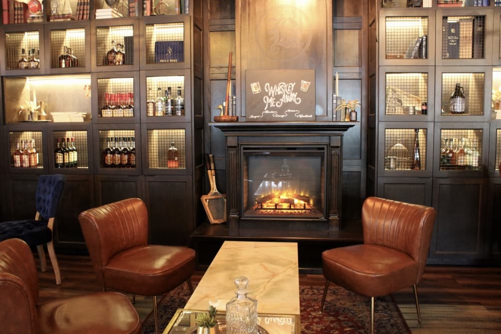 Whiskey room with seats and fire place