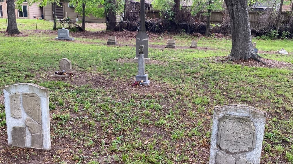 The photo shows graves at Willis Wood Cemetery.