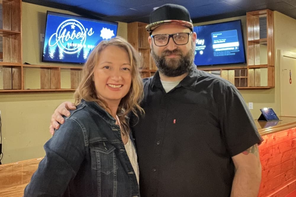 The couple poses for a photo.