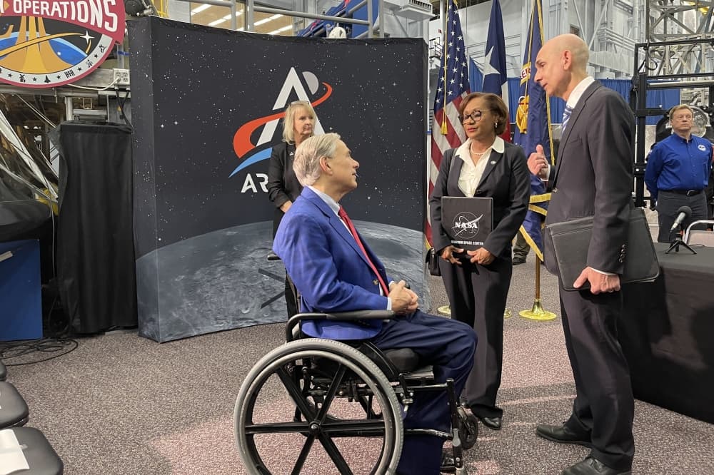 Gov. Greg Abbott speaks with Johnson Space Center Director Vanessa Wyche and Texas State Rep. Greg Bonnen. Abbott, along with other officials, announced the new members of the state's space commission on March 26. (James T. Norman/Community Impact)