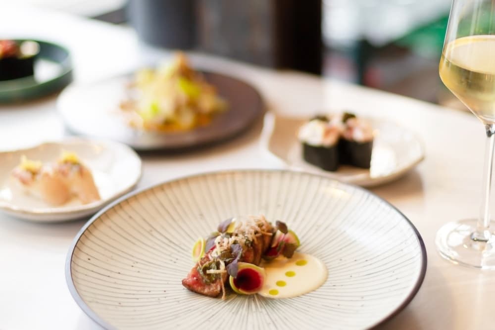 A photo of an assortment of omakase dishes.