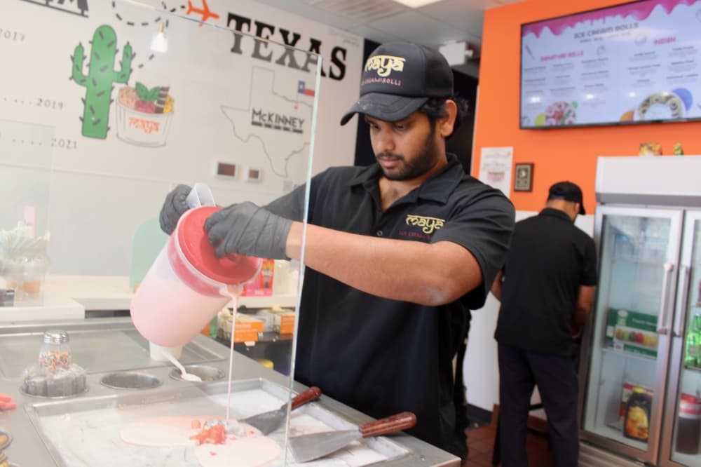 Man pouring cream for rolled ice cream