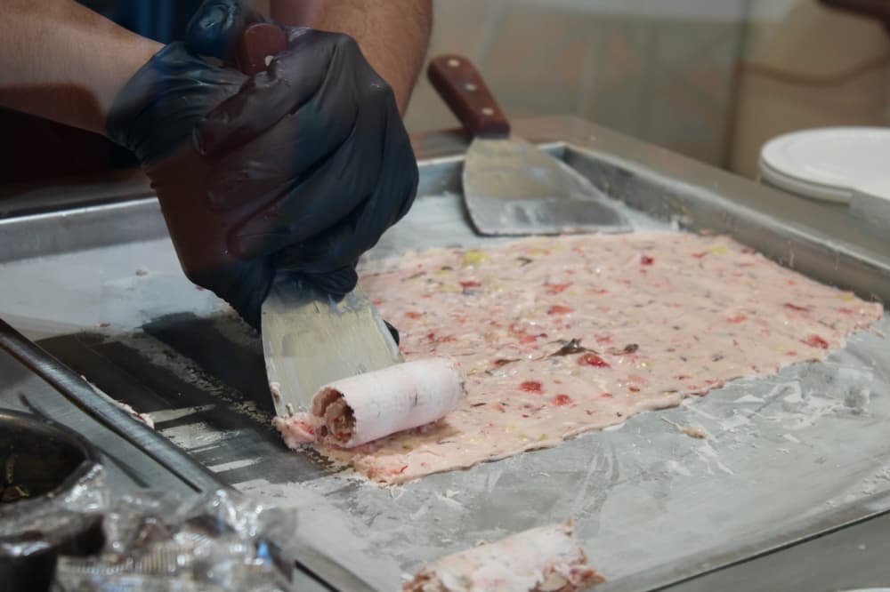 Hands rolling ice cream