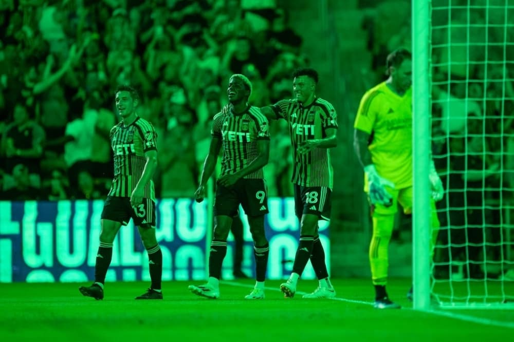 Soccer players are shown walking on the field.