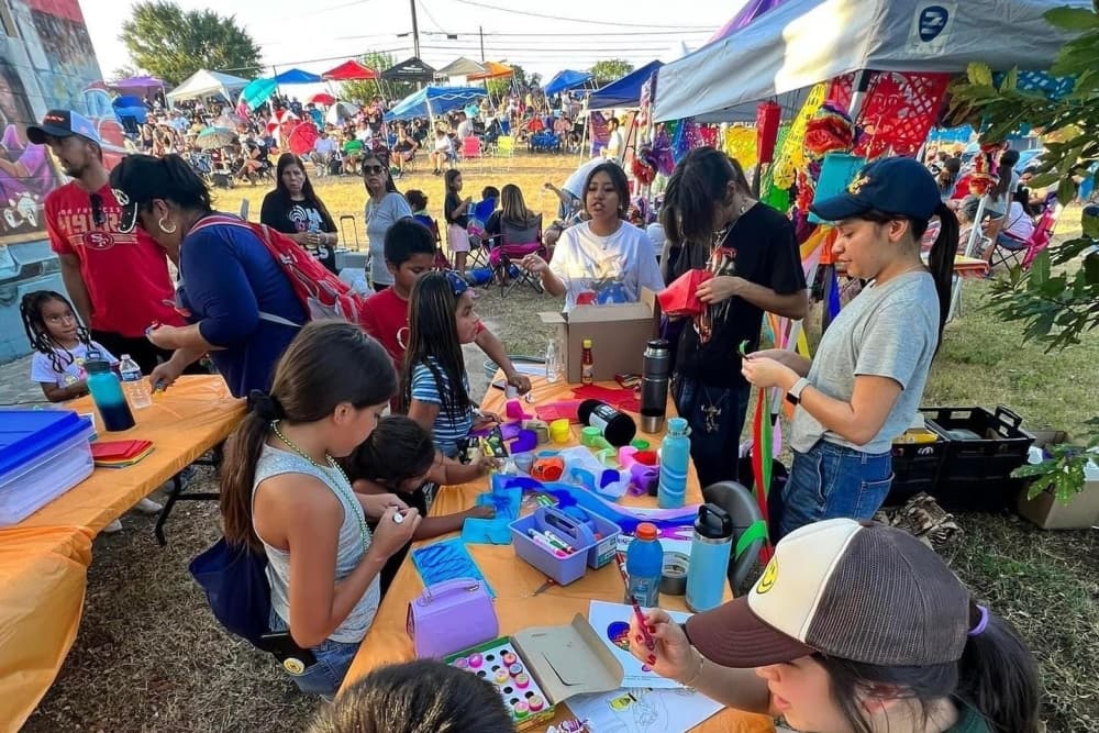 People do crafts outside at a previous Fiesta Austin.