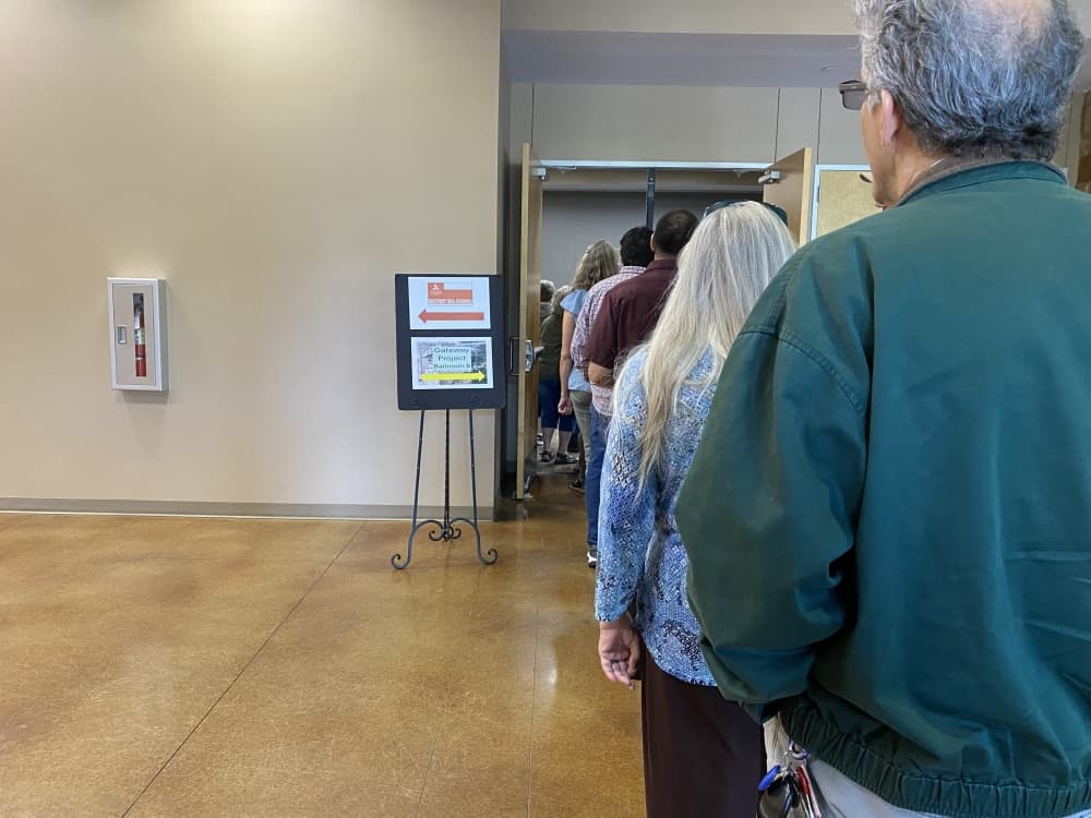 Adults standing in a line.