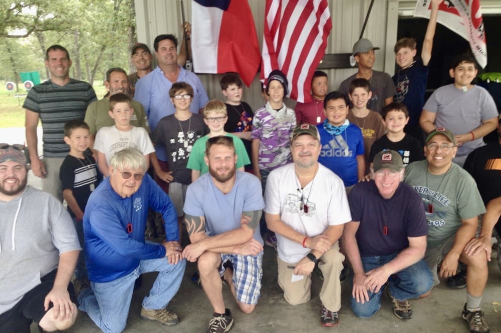 A group of boys and men posing for a photo.