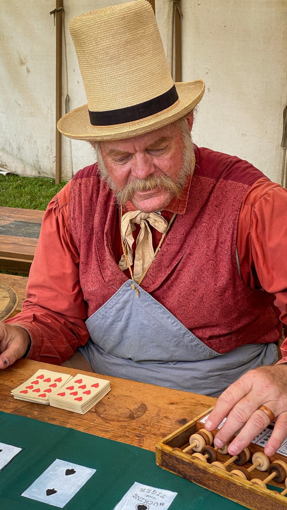 A man wears reenactment clothes while playing a game.