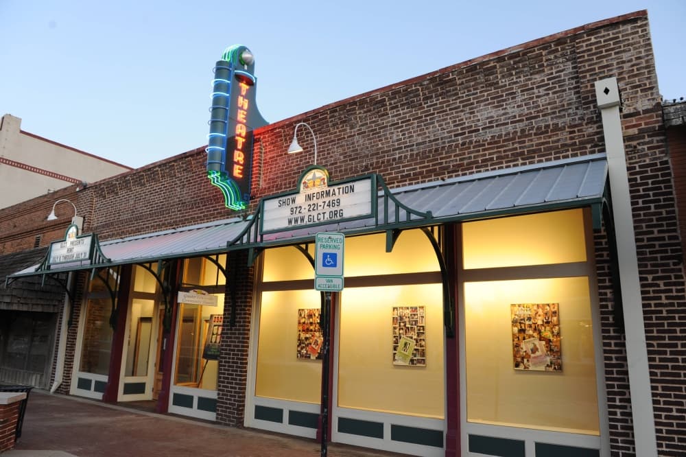 Front of a building with Lewisville Playhouse signage. 