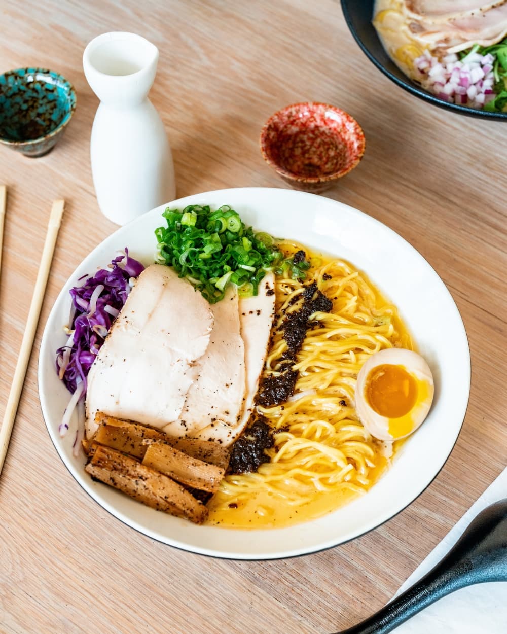 The signature ramen dish is shown on a table.