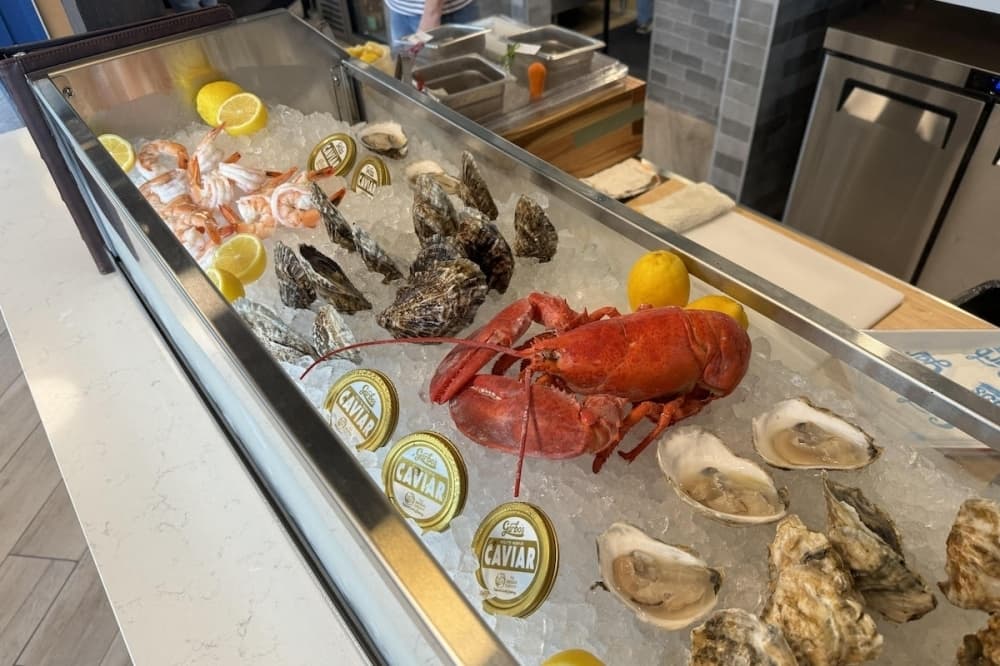 A bar is shown filled with raw fish on ice.