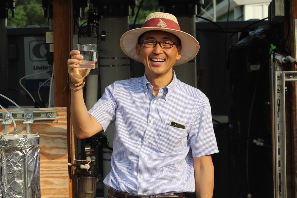 Dr. Keisuke Ikehata holding a glass of water