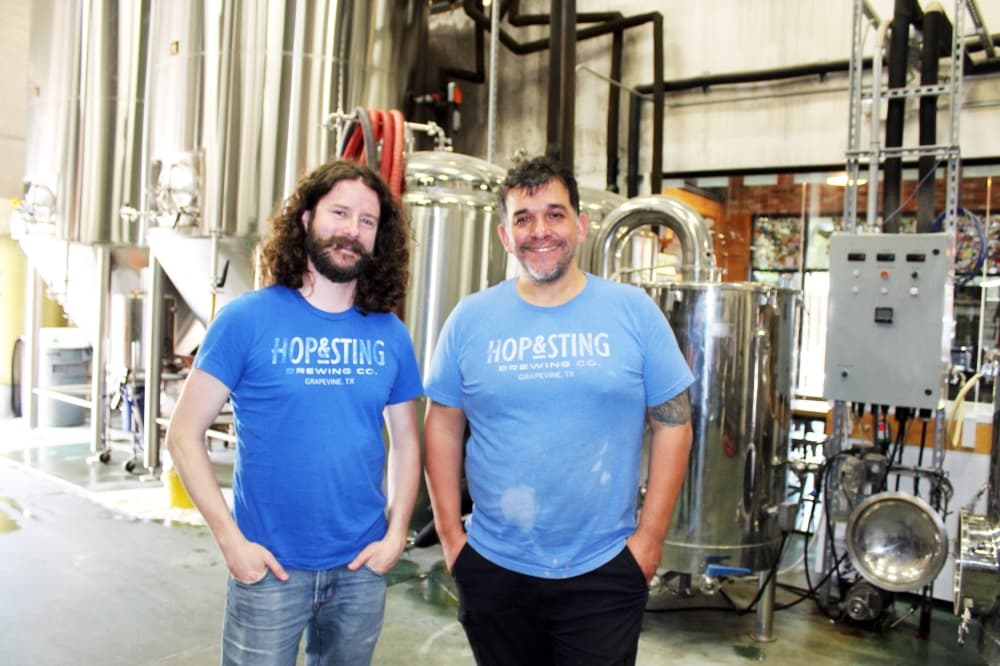 Two males standing in a brewery.