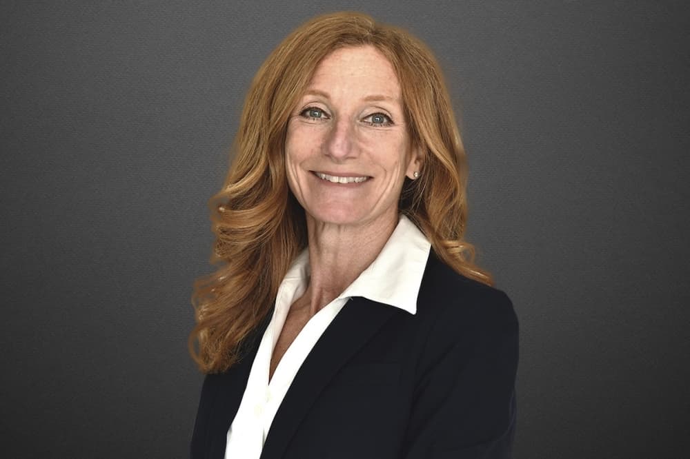 a woman smiles in a headshot photo