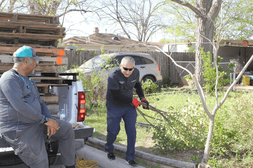 Schertz Mayor Ralph Gutierrez picking up tree limbs. 