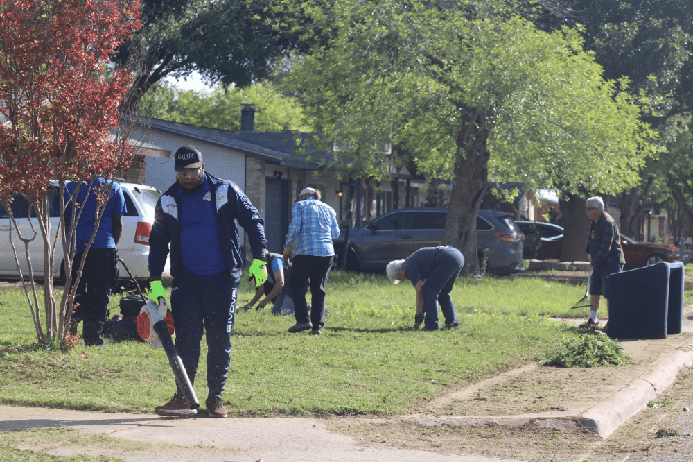 Volunteers doing yard work. 