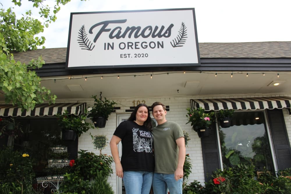 Erika and Tanner Mitchell in front of the Famous in Oregon storefront.