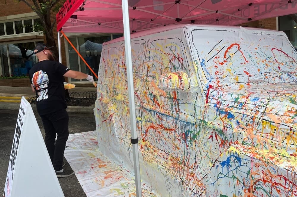 an artist slinging paint 