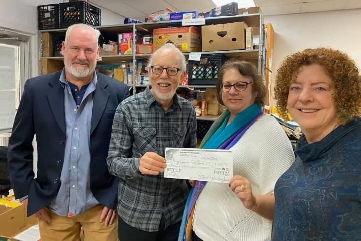 San Marcos Art League board members Josh Farrell (far left), Tracy Weinberg and Nancy Brown (far right) present a fundraising check to a Hays County Food Bank representative. (Courtesy San Marcos Art League)