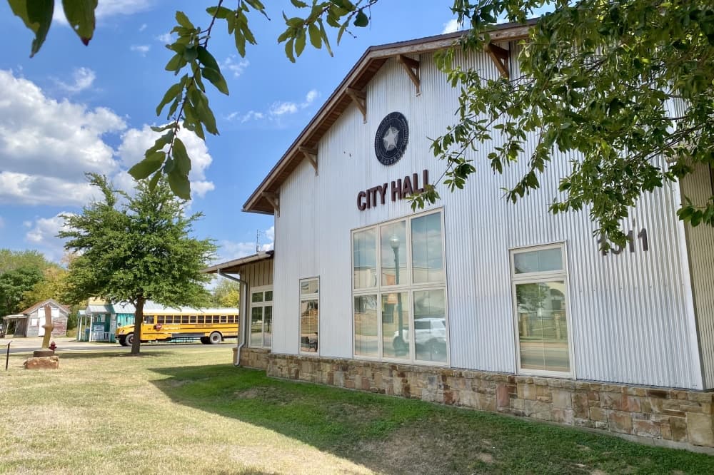 The white city hall exterior is shown.