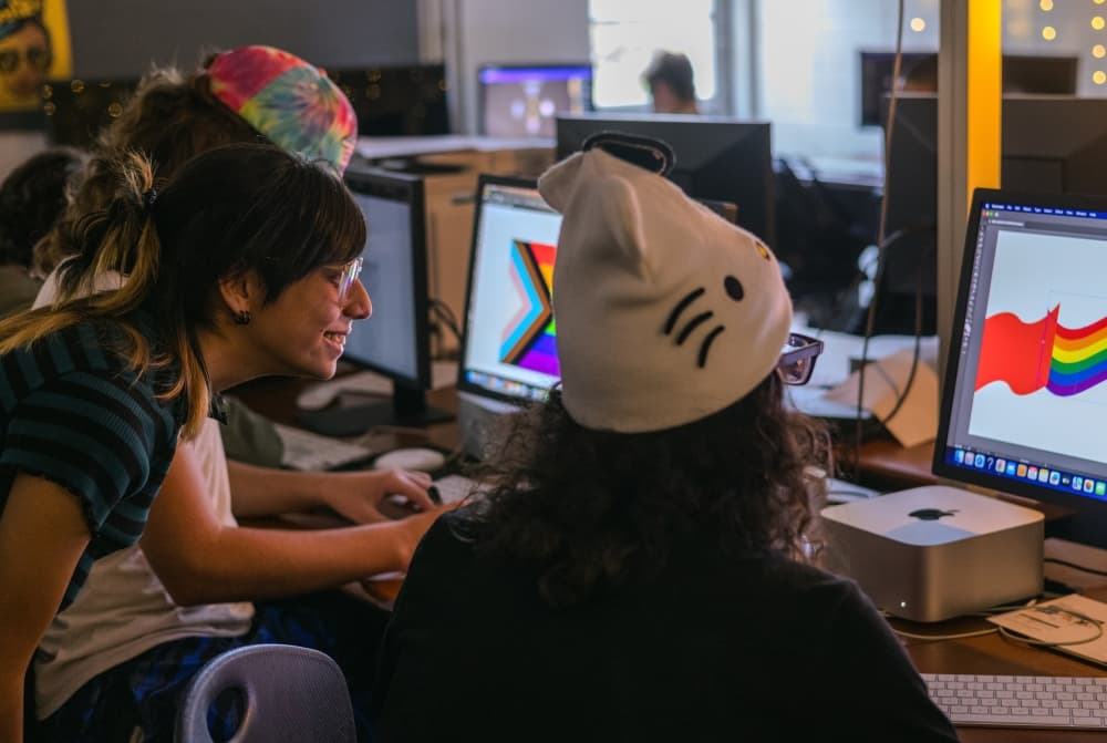 Teens work on a computer project.
