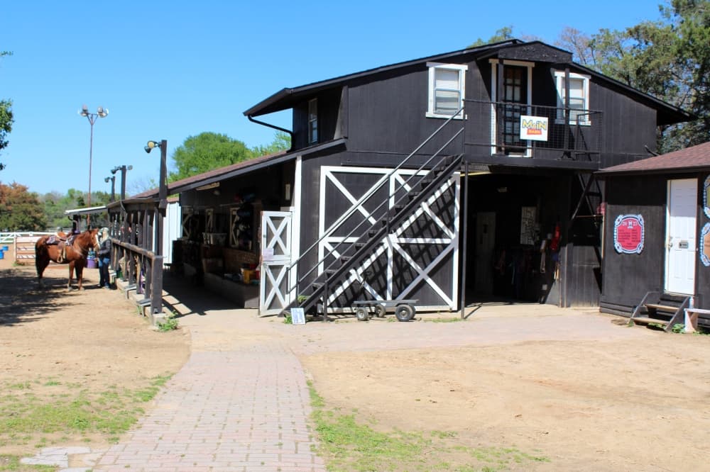 Barn painted black with white accents. 