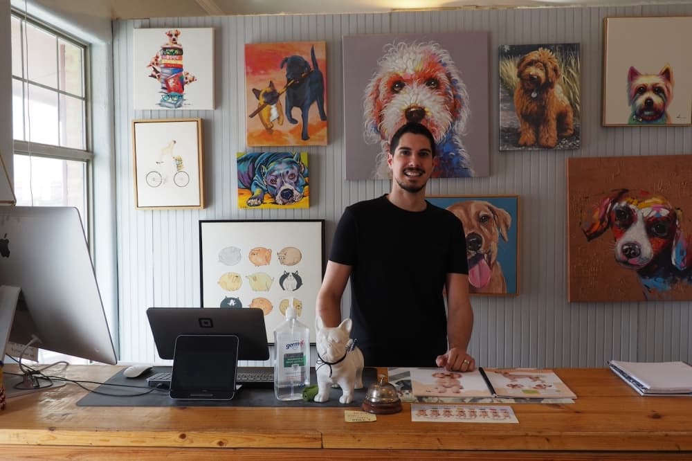 John at the welcoming desk inside The Paw Spa.