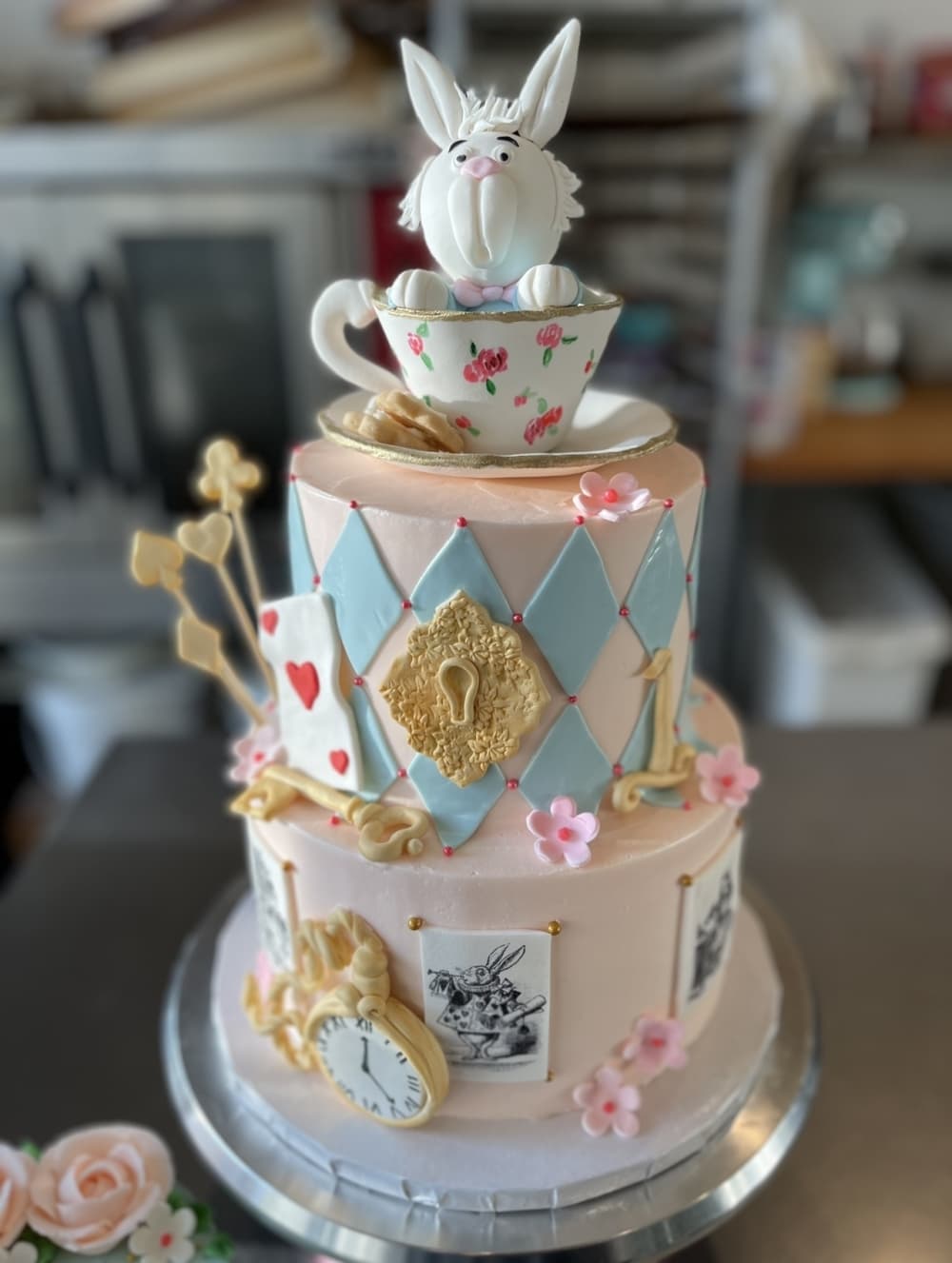 Two layer cake with Alice in Wonderland theme.
