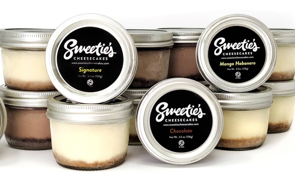 Multiple jars filled with cheesecake. 