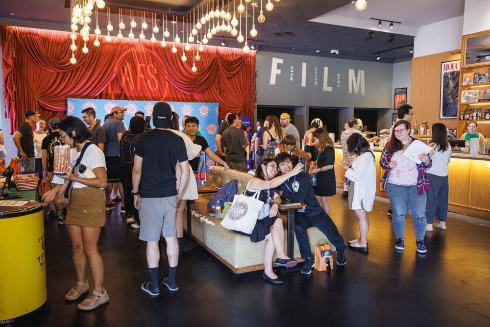 People gather before going into the cinema.