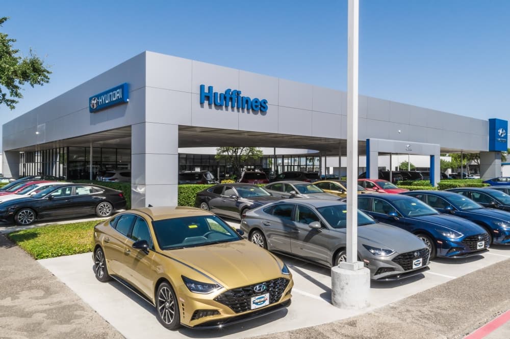 Car dealership with Huffines and Hyundai signage. 