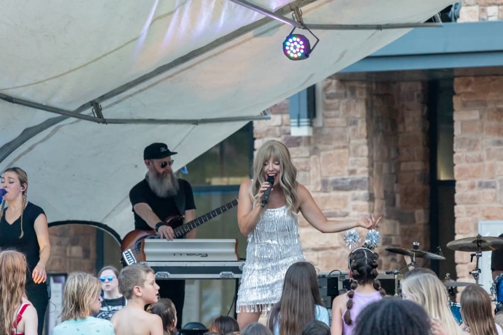 Band performing on an outdoor stage. 